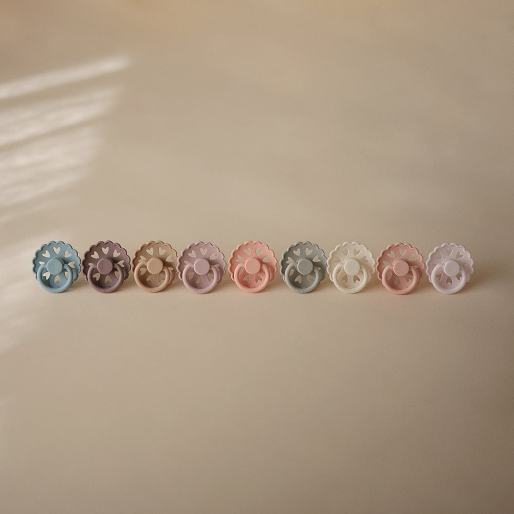 række af sutter i blå, lilla, rosa og andre pastel-nuancer, 9 stk fra danske Frigg fairytale kollektion, med små hjertehuller
