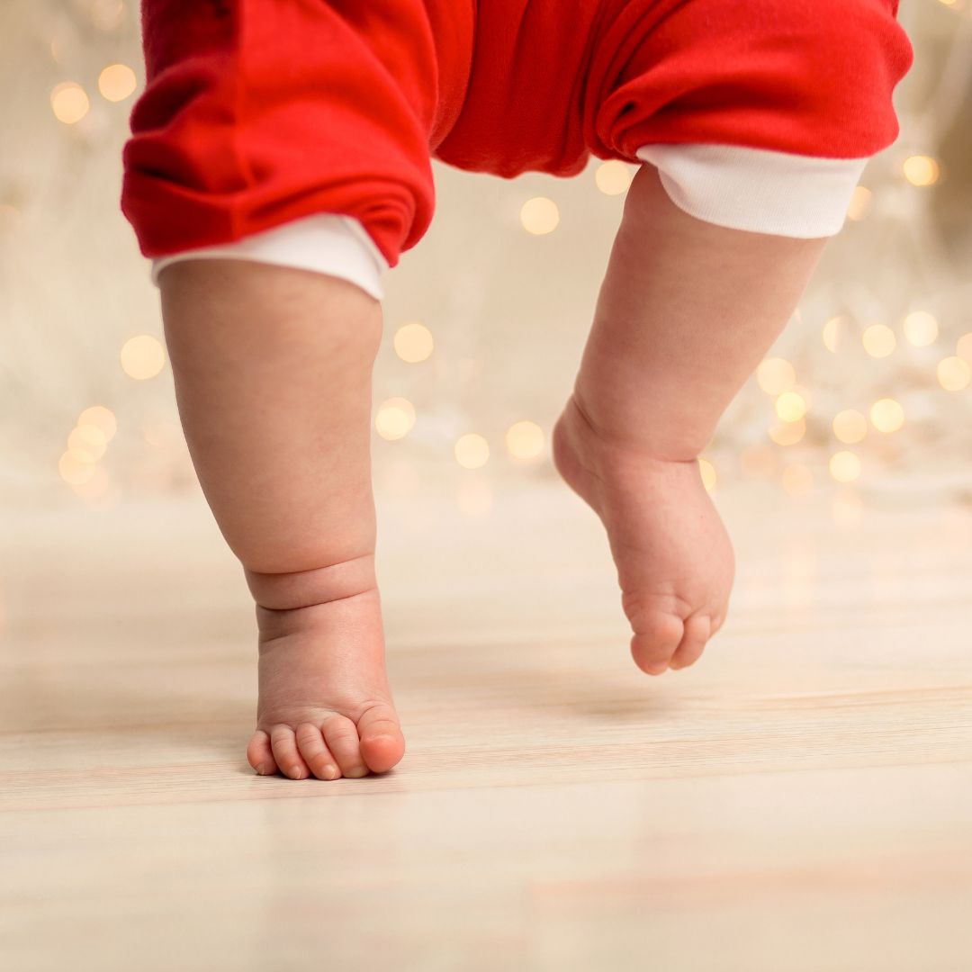 små babyben med røde nissebukser går på bare fødder, find adventskalender til baby pige 0-1 år hos Nordic Simply.