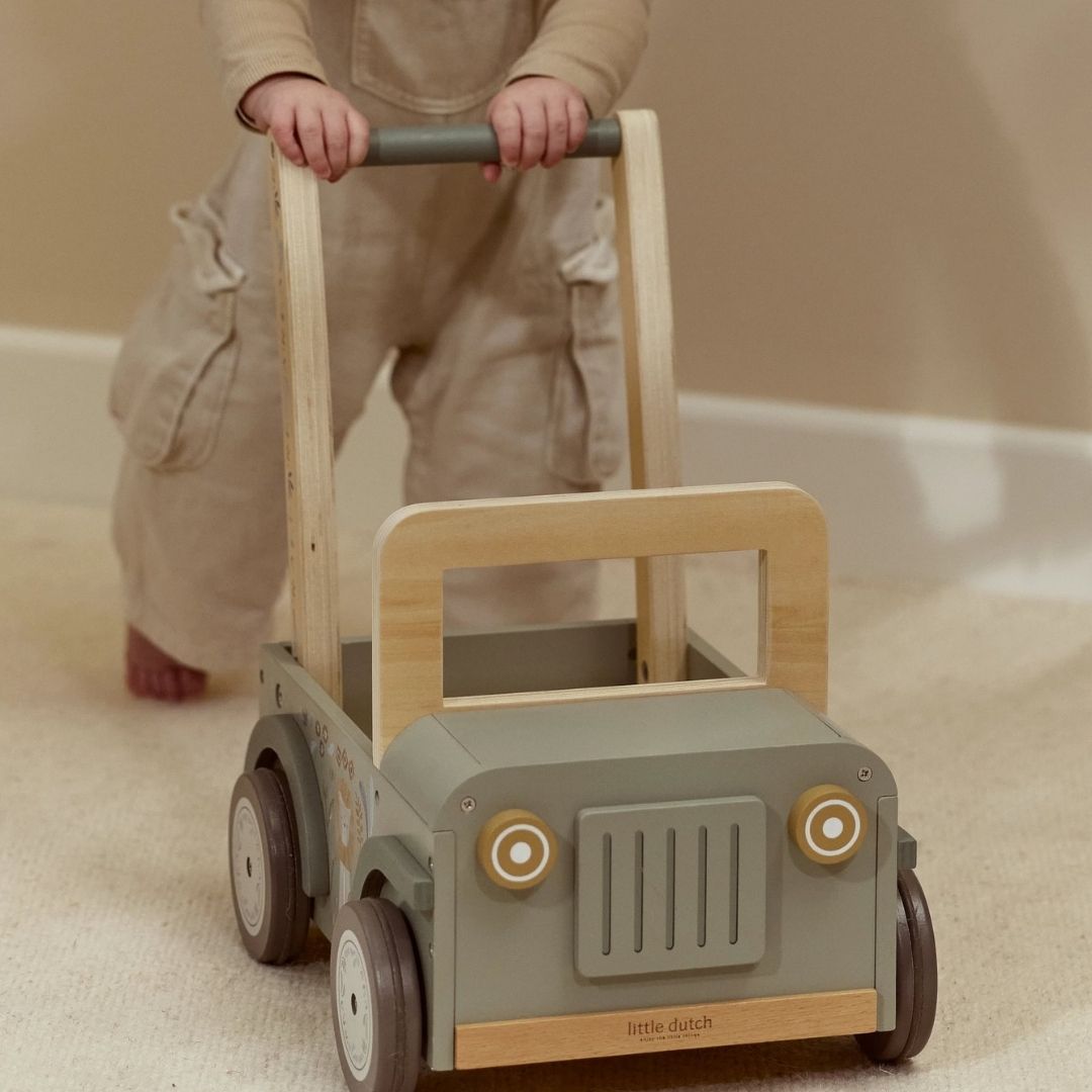 baby bag grøn safaribil gåvogn på lyst gulvtæppe, prewalker i træ, a la jeep, med plads til legetøj, fra Little Dutch Safari kollektion.