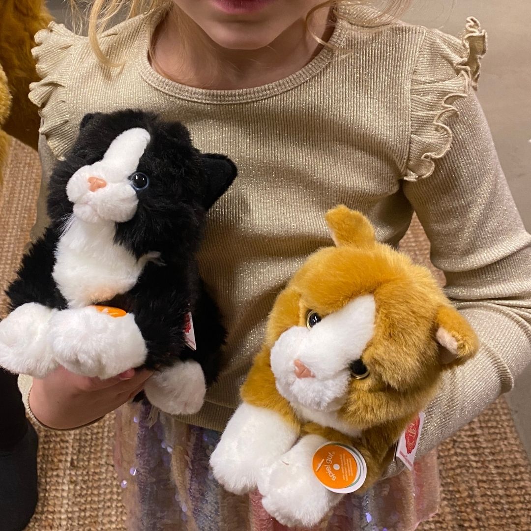 Barn med 2 katte bamser i rød og sort, ligner ægte killinger, fra Teddy Hermann fås hos Nordic Simply