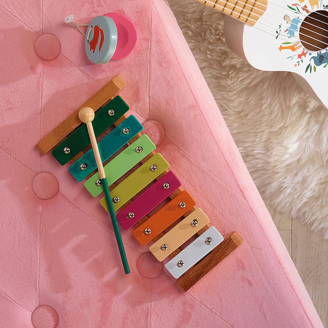 musiksæt i lyse pastelfarver med 4 instrumenter til rytme og leg, her ses tambourin og kastagnetter tæt på, på rosa baggrund. God til børn fra 3 år og op, fås hos Nordic Simply.