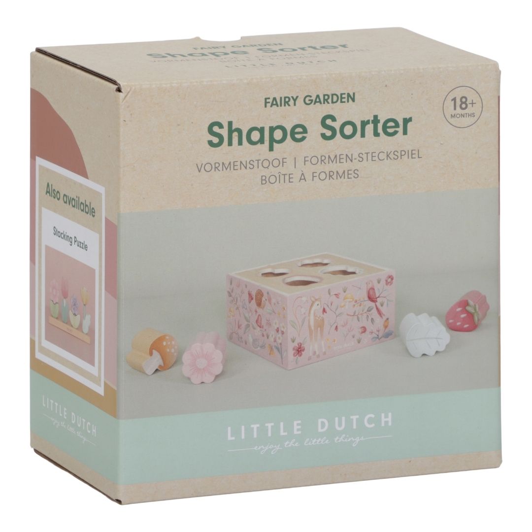 rosa puttekasse med fire huller til figurer med skovens motiver: blomst, blad, jordbær og svamp, perfekt til sorterings og stableleg, fra Little Dutch, her set i indpakning.