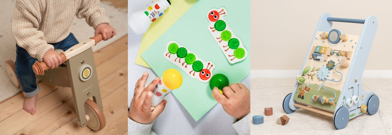 Dreng på grøn løbecykel i træ, hænder farver på papir, blå aktivitetsgåvogn i lyst værelse, julegaver til dreng 1-år hos Nordic Simply