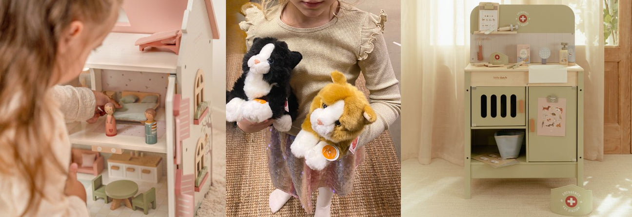 pige ser ind i stort lyst dukkehus i træ med rosa tag, pige holder en sort og en rød kattebamse, dyrlægebord i træ med komplet udstyr, julegaver pige 4 år hos Nordic Simply
