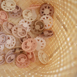 bunke af sutter i beige og rosa nuancer fra danske Frigg fairytale kollektion, med små hjertehuller
