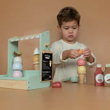 Child playing with Little Dutch wooden ice cream shop from Nordic Simply, creating fun ice cream cones with included toppings.