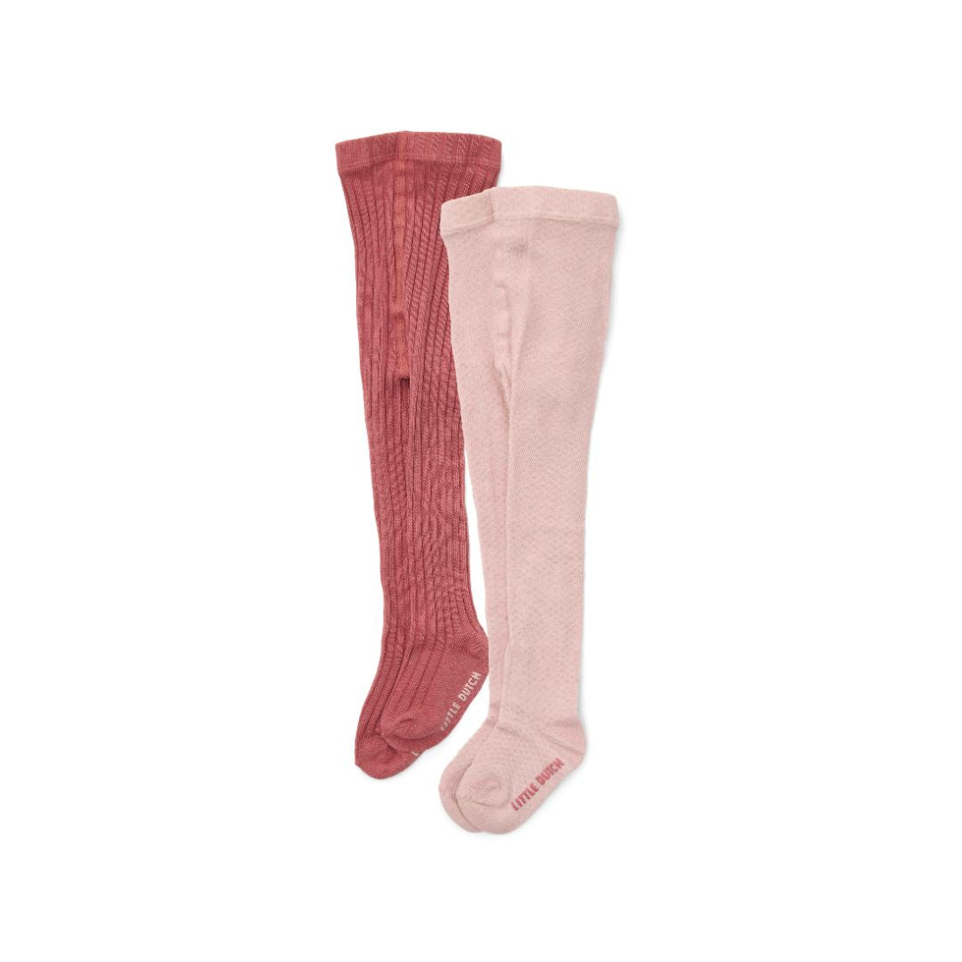 To par strømpebukser til baby, rosa og pink, set på hvid baggrund.